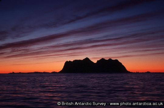 Sunset illuminating bands of cirrus clouds