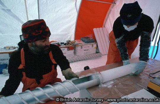 International European Project for Ice Coring in Antarctica (EPICA) project: Dronning Maud Land reconnaissance phase.  Scientists remove a core from the barrel of an ice core drill: analysis of the ice, which fell as snow more than 1000 years ago, will reveal changes in climate and the composition of the atmosphere.