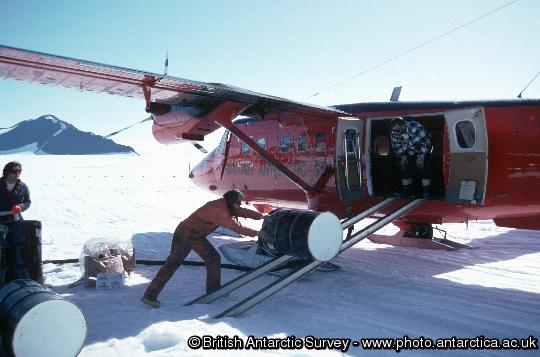 Fuel drums being delivered to Fossil Bluff by Twin otter. Fossil Bluff is a forward facility for refuelling aircraft, 90 minutes flying time from  Rothera. There is a 1200 m unprepared snow runway (skiway) marked by drums 1 km south of the station. Twin Otter aircraft ferry drums of fuel from Rothera to Fossil Bluff to maintain the fuel depot. Fossil Bluff also forms a transit station for summer field parties.