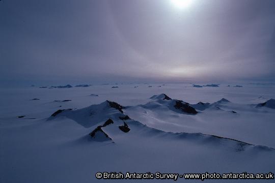 A nunatak stands out from the Antarctic Ice Sheet south of the Antarctic Peninsula