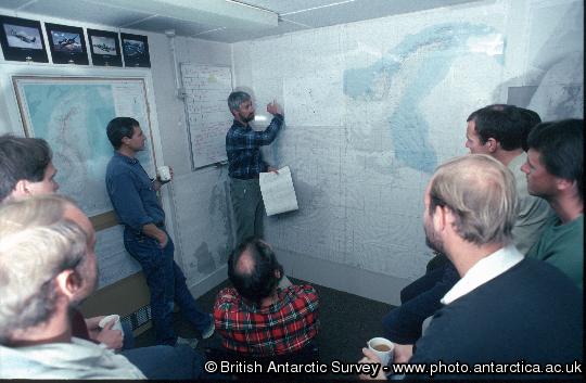 Morning briefing in the Operations Room at Rothera. Weather reports being given to pilots.