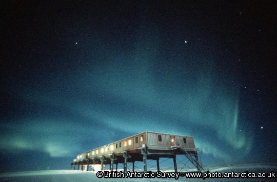 Aurora over Halley 5 ACB.  Aurora are caused by the precipitation of charged particles from space towards the magnetic poles driven by plasma winds and magnetic storms.