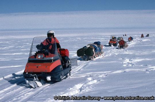 A remote field party travelling between sites using Bombardier skidoos and Nansen Sledges.  The party of four required more than 6 tonnes of equipment but were autonomous for 10 weeks. Snow-mobiles are extensively used at the BAS stations and at remote field locations. These small vehicles are used for personal transport and for towing Nansen sledges. BAS operates Bombardier Ski-doos which are simple to ride with just a twist grip throttle and a brake. They have a fully automatic transmission and a track underneath with skis at the front to steer. Ski-doos can attain speeds of up to 50 mph on smooth snow.