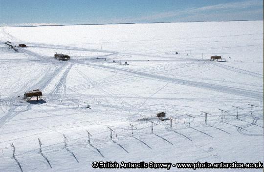Halley research station from the air. SHARE aerial array in foreground with the three platforms, garage and summer accommodation in the background