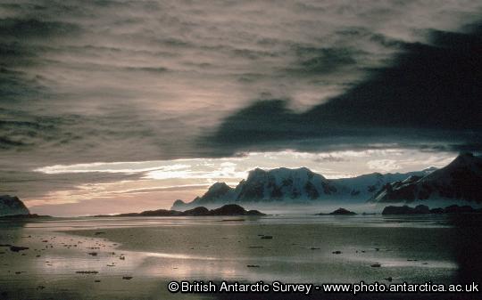 Adelaide Island from Rothera and clouds relectd in a calm sea