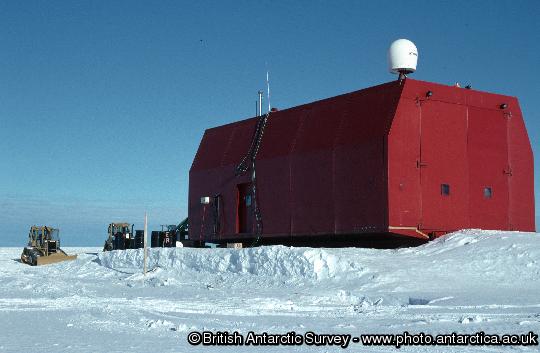 Garage on skis showing satellite communications dome. The garage is built on skis and is moved to a new location each year to prevent it becoming buried in snow.