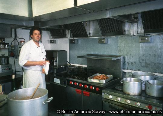 Cyril Millet, the wintering Rothera Chef preparing lunch in the kitchen.