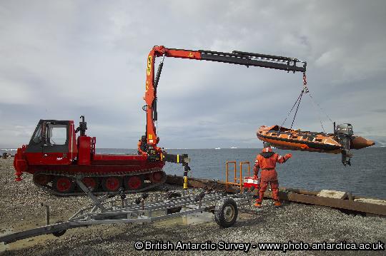 Inflatable boat being lowered into the water at Rothera's wharf. Boat transport allows both marine and terrestrial biologists to investigate sites further from the Station.