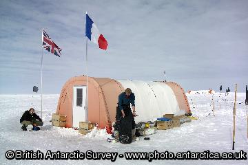 Living accommodation at a Berkner Island drilling site.
Scientists have succeeded in drilling 1000 metre-deep ice core and reached bedrock. The core gives a continuous record of the climate on Berkner spanning the past 30,000 years. This period is particularly interesting as it includes the dramatic tranition from the last ice age into the current Holocene warm period, when the average temperature of the Antarctic rose by 8C. Situated at the southern end of the Atlantic Ocean, the Berkner Island coast will give a clear view of the southern response to changes in ocean currents that are believed to have occurred during this period.
This image is associated with the 2005-2010 BAS science programme: CACHE- Climate and Chemistry: Forcings, Feedbacks and Phasings in the Earth System.