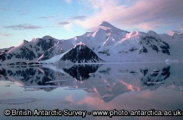 Adelaide Island from Rothera and clouds relectd in a calm sea