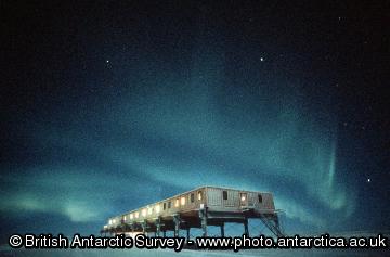 Aurora over Halley 5 ACB.  Aurora are caused by the precipitation of charged particles from space towards the magnetic poles driven by plasma winds and magnetic storms.