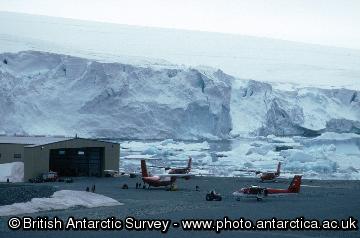 The air facility at Rothera Research Station with the hangar in the background and 4 aircraft (Dash 7 and Twin Otter) in the foreground