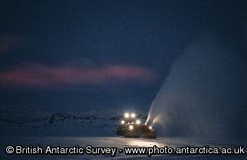 Snow Blower clearing drift in front of the aircraft hangar.