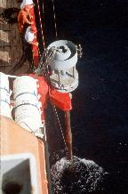 Long Piston Corer lowered into position but still clamped to ship (JCR) during sea trials. The Long Piston Corer has the ability to take virtually undisturbed cores of the sediment on the seabed. This is achieved by using a stationary piston which is held in contact with the sediment surface through a series of wires and pulley wheels which are attached to a base plate on the seabed. Using this method the corer is able to penetrate the sediment under its own weight independently of the ship's motion.
