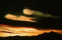 Nacreous (also known as mother of pearl or stratospheric) clouds.  These clouds form at around 20km altitude in the ozone layer and are instrumental in the process of ozone depletion.  Because of their altitude they remain illuminated by the sun, long after sunset on the ground.