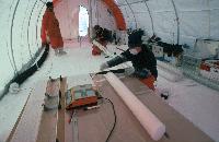 International European Project for Ice Coring in Antarctica ( EPICA ) project. Scientist cutting up an ice core: analysis of the ice, which fell as snow more than 1000 years ago, will reveal changes in climate and the composition of the atmosphere.