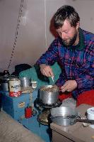 Preparing a meal inside a pyramid tent